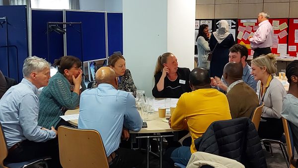 A group discussion with participants sat round a table at our Advocacy Development Fund event