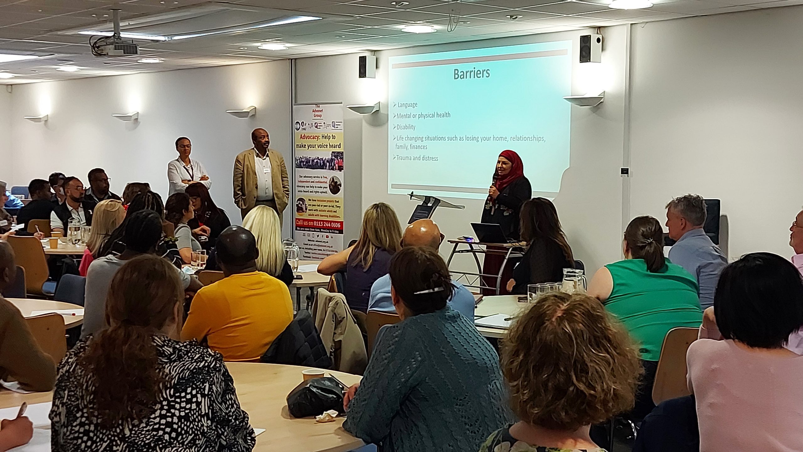 Bushra, our Self-Advocacy Manager, talking in front of people about barriers to accessing advocacy