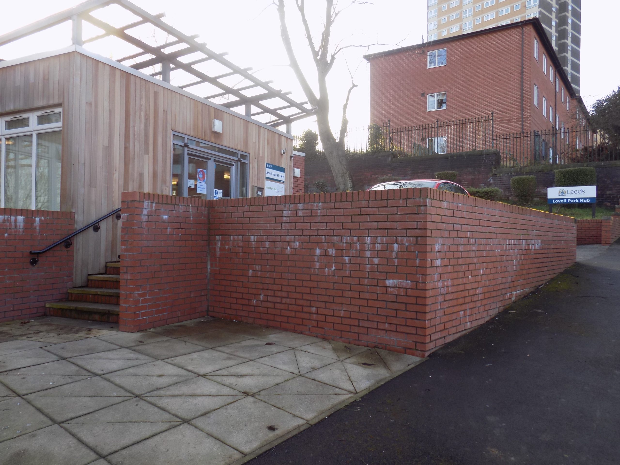 Photo of the main entrance to the Lovell Park Hub, with a set of stairs leading to the doors. This is where Leeds Autism AIM have weekly hub sessions.