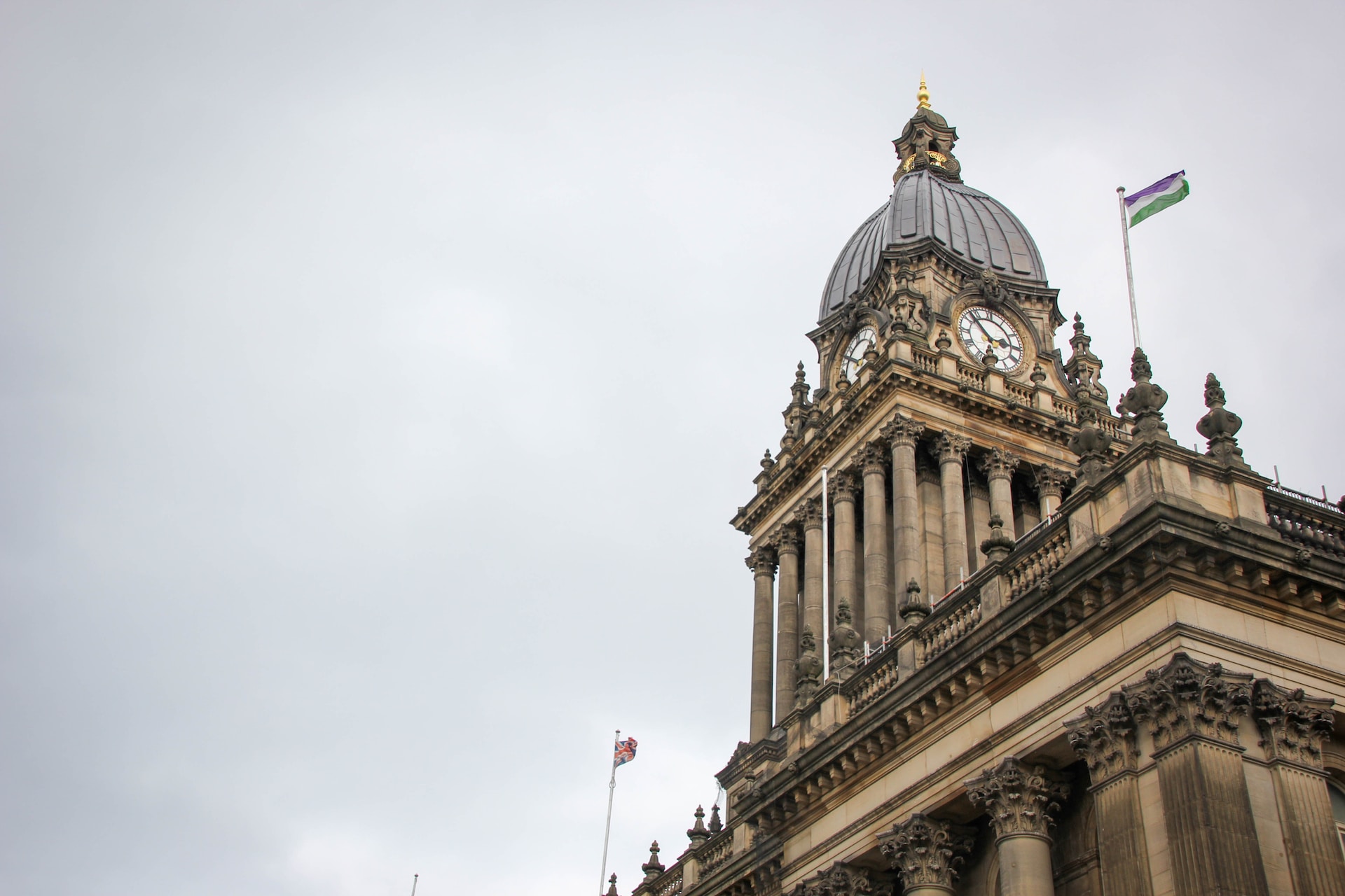 A picture of the clock on top of Leeds Town Hall, with a grey sky above it.