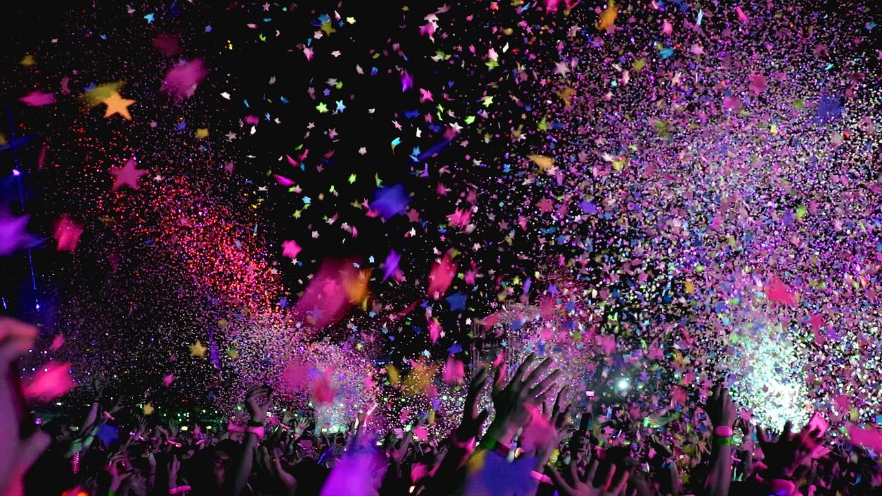 A photo of colourful confetti falling from a ceiling in a nightclub, during a party.