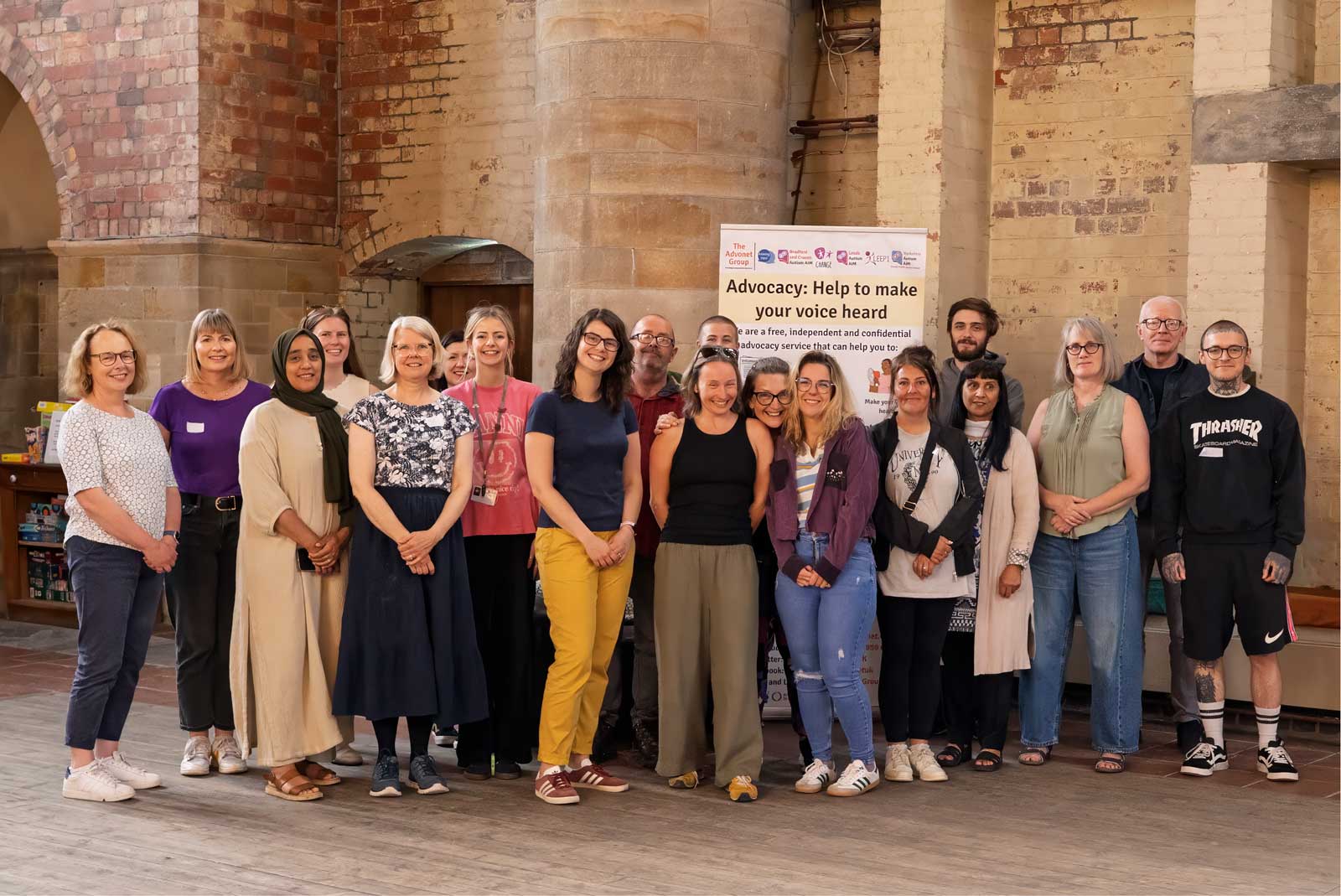 A photo of members of our advocacy team, stood in front of a roller banner with The Advonet Group's logos.