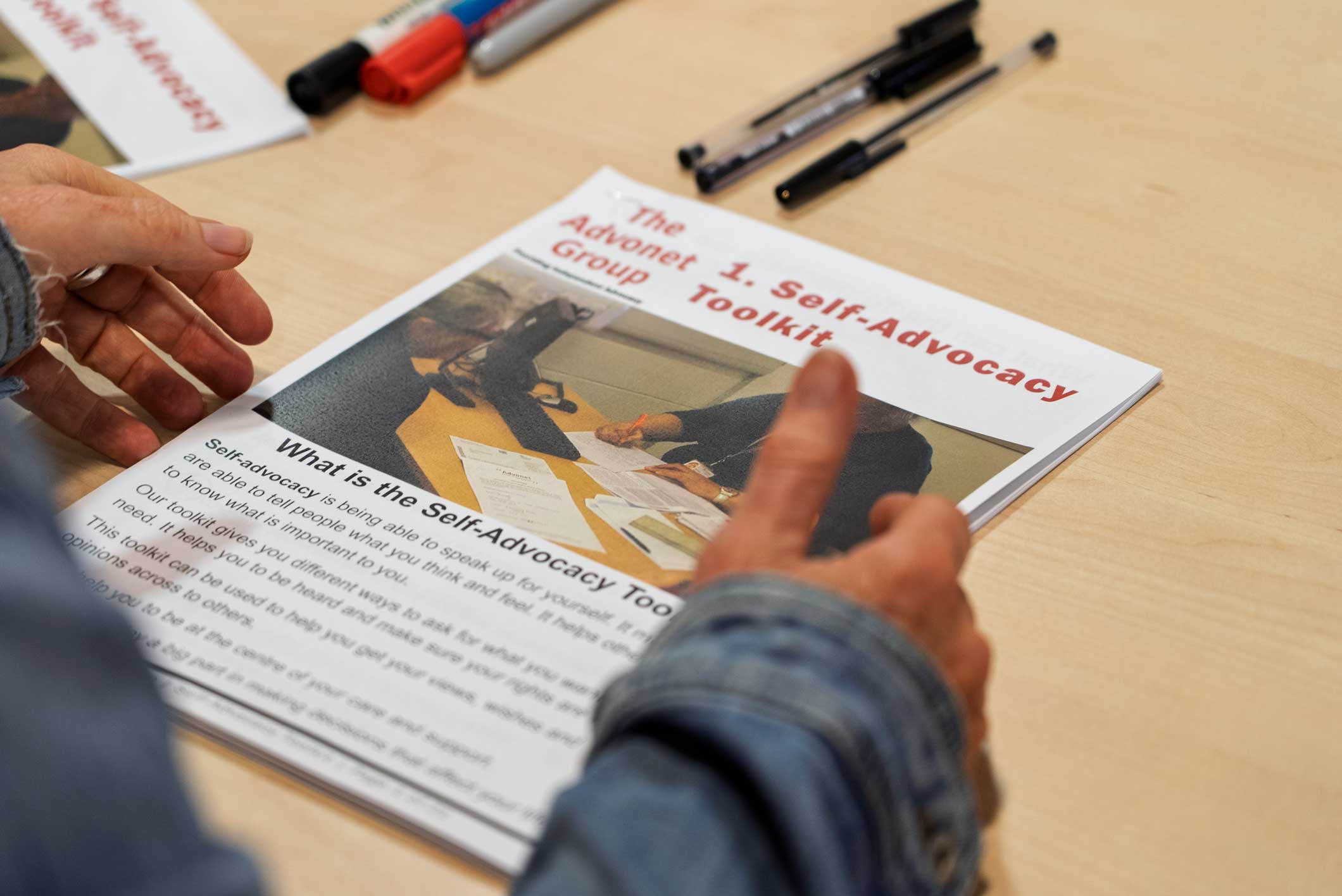 A photo of our Self-Advocacy Pack, sat on a wooden table.