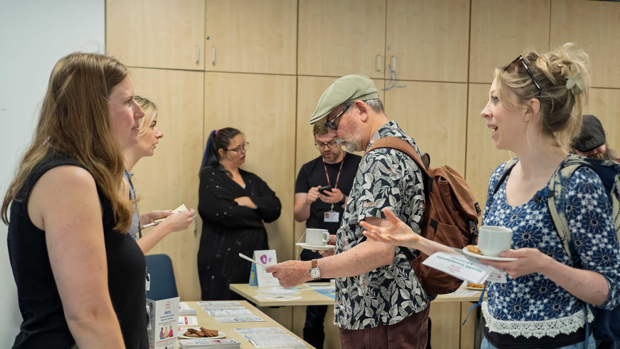 A photo of some of our advocates speaking to people at an event.