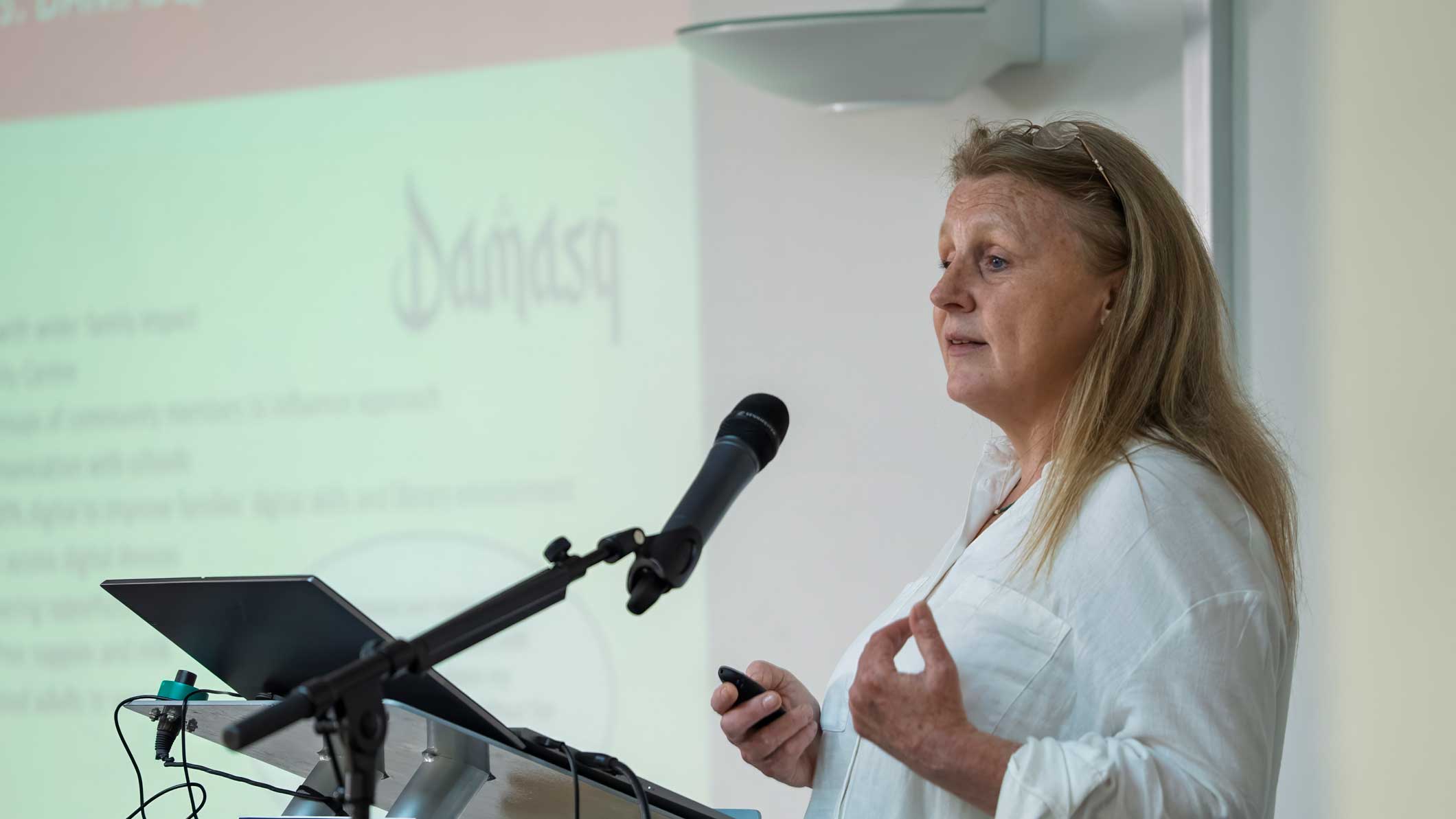 A photo of Wendy Cork, our Deputy Chief Executive and Development Director, speaking at an event.
